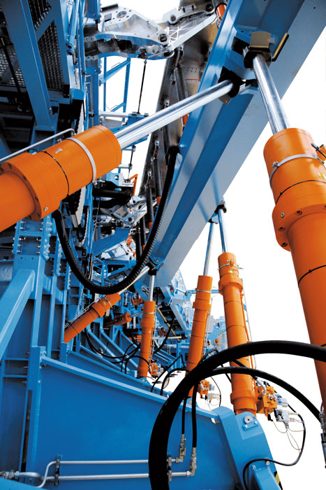 Orange hydraulic cylinders in a test bench for ariplanes